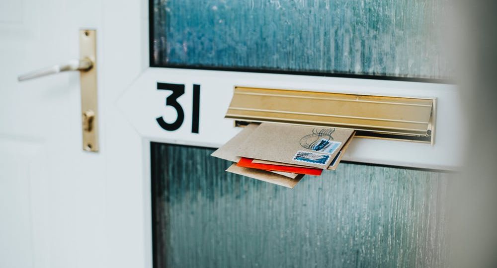 Image of mail sticking out of a mail slot