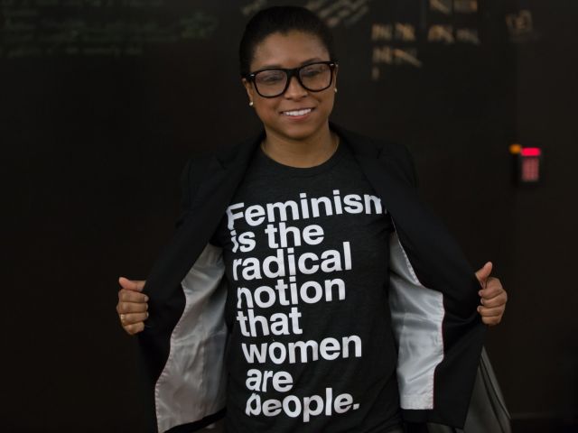 Image of person wearing a T-shirt that says "Feminism is the radical notion that women are people."