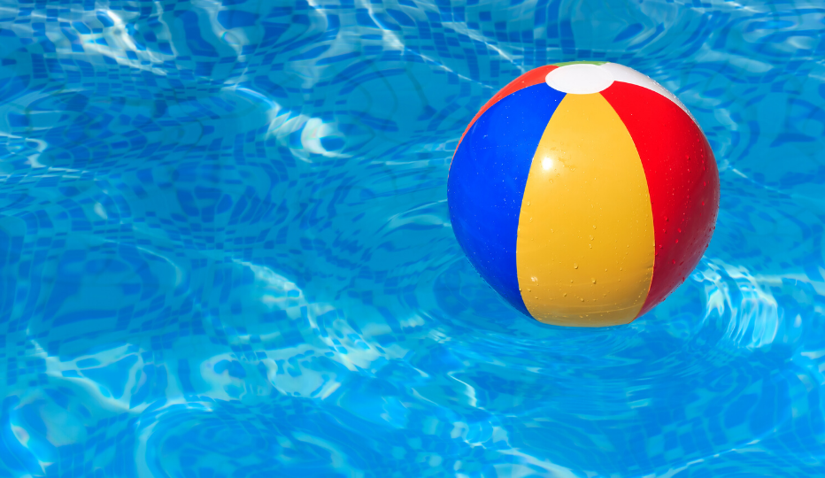 Blue, yellow and red beach ball floating in a pool