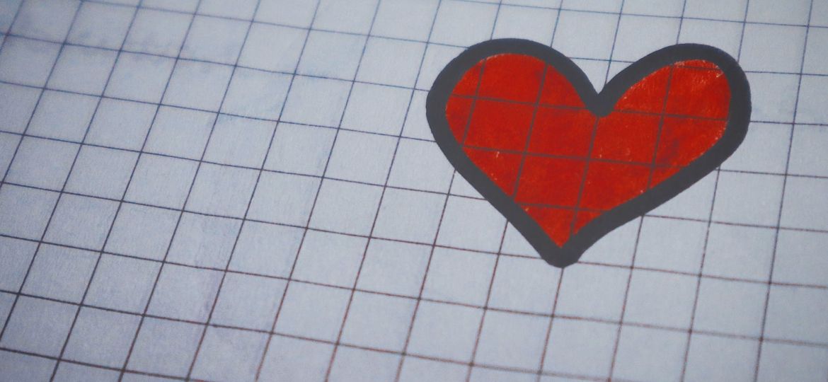 Red and black heart drawn on graph paper