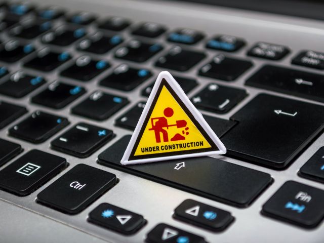 Yellow and red under construction triangle on top of keyboard